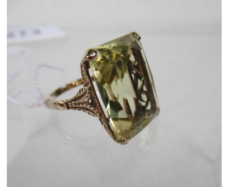 A 9ct gold citrine dress ring, the large rectangular stone in claw mount, the shoulders formed as leaves, to a plain shank.