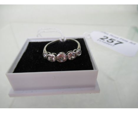 A five stone half-hoop diamond ring, the mixed cut stones in rub-over mounts to plain shank. Condition Report: Not hallmarked