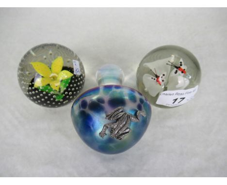 A Caithness glass paperweight titled 'Petals', together with two further paperweights.