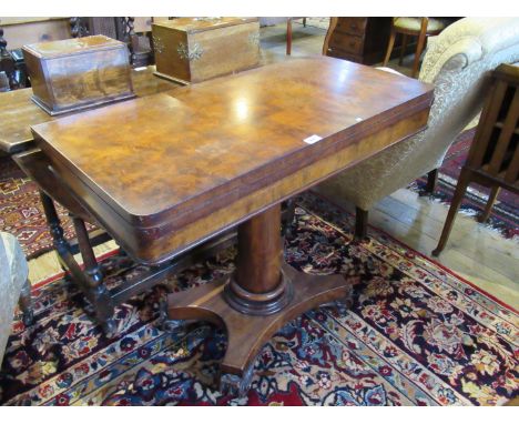 A Victorian mahogany swivel top fold-over card table, over plain column on quatrefoil base, 97cm wide.