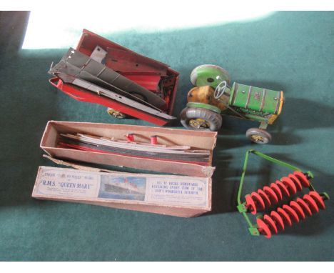 A boxed Chad Valley model of RMS Queen Mary, early 20th century, together with a Mettoy tin plate tractor and plough, an unbu