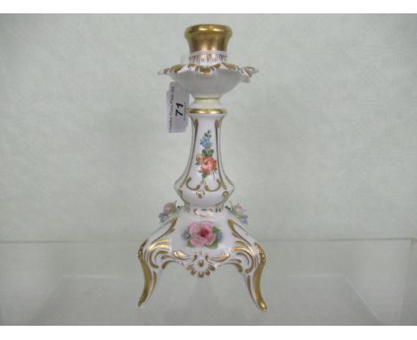 A Dresden porcelain candlestick on tripod base, signed J Heubamer, the stick with encrusted floral decoration and gilt finish