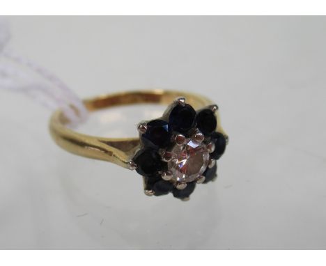 An 18ct gold sapphire and diamond cluster ring.