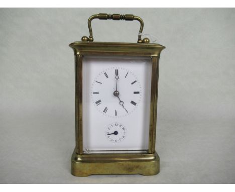 A French gilt brass carriage clock, the bell striking movement signed 'Brevete, Paris', the enamel dial bearing Roman numeral