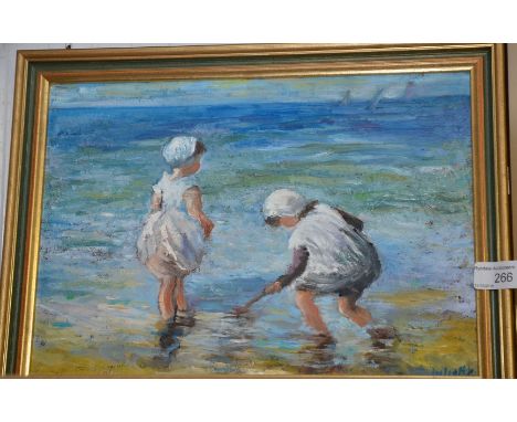 Small gilt framed oil on board depicting children playing in the sea
