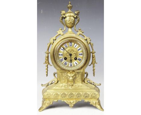 A 19th century French brass mantle clock, with Roman numeral chapter ring and movement striking on a bell, 39cm