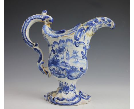 A Delft Rococo style ewer, classically modelled upon a scroll base and painted in blue with two classical scenes depicting fi