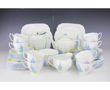 A Grafton Art Deco Shelley style tea service, each piece florally painted, comprising; twelve teacups and saucers, twelve pla