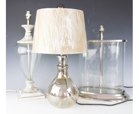 Four assorted table lamps, comprising; an oval straight sided glass and chromed table lamp, 43cm high, a smokey glass base an