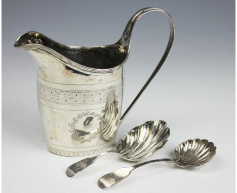 A George III Newcastle silver cream jug, engraved with geometric banding and vacant cartouche to either side, with reeded rim