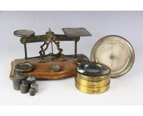 A set of early 20th century brass postal rate scales, mounted upon moulded wooden platform, along with an Elliot Bro's London