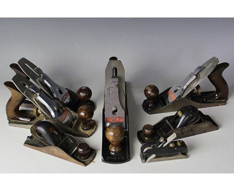 A collection of eight vintage Stanley wood working planes in original boxes, comprising No 5, No 4 (x3), 50s, No 130, No 110 