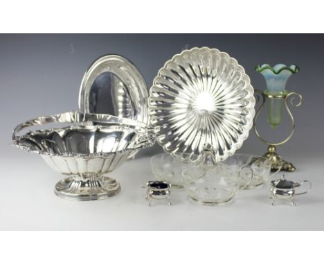 A selection of silver plated wares comprising; a three piece condiment set, an epergne with green glass crimped vase insert, 