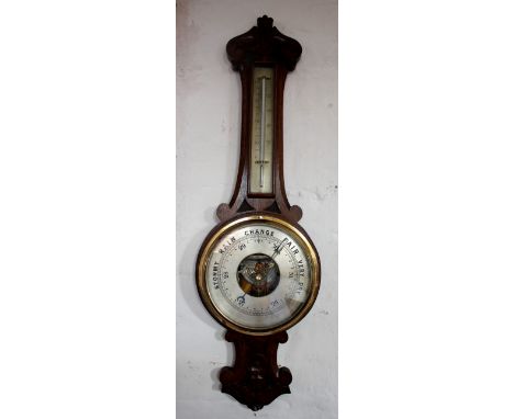 An Edwardian carved oak aneroid barometer, with thermometer, 84cm
