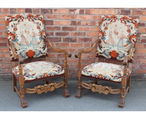 A pair of 17th century style carved beech arm chairs, the backs and seats with gross and petit point tapestry depicting figur