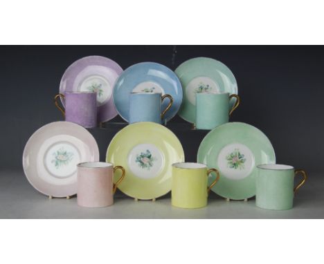 Six pairs of Shelley china coffee cans and saucers, each of a different colour with floral sprays to the saucers (12)