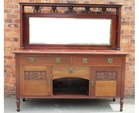 An Art Nouveau mirror back dresser in the manner of Liberty & Co, with mirror back above three drawers with brass handles dec