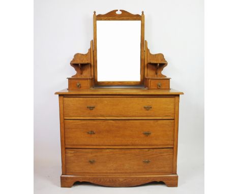 An Edwardian golden oak dressing table, with mirror and two drawers, above three graduated long drawers, on plinth base, 146c