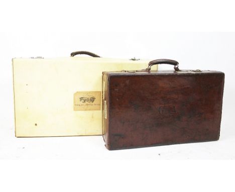 A Vintage vellum suit case, the lid with a label for 'Hotel Houmet Du Nord, Grand Havre Vale Guernsey', and initialed EH, the