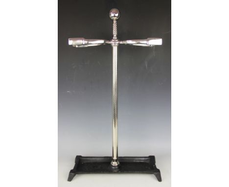 An equestrian stick stand, designed as a central riding crop with two stirrup stick holders, 71.5cm high