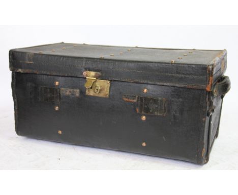 A late 19th century leather and iron bound canvas travelling trunk, the hinged lid enclosing a twin handled tray and red inte