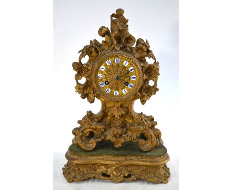 A 19th century French gilt metal mantel clock, cast with flowers, gilt dial with enamel chapters, drum movement by Connell of