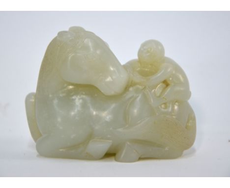 A green jade of pale or whitish hue, carved as a monkey seated on the back of a recumbent horse, 7.5 cm long, post Qing Dynas