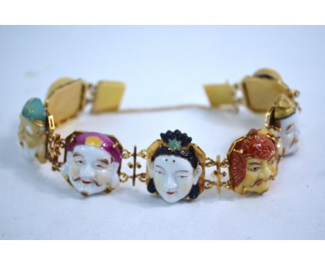An unusual yellow metal bracelet, designed with seven linked panels of octofoil form; each panel decorated with a member of t