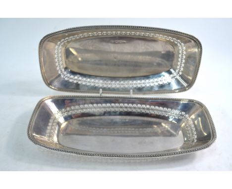 A pair of pierced oblong bread-dishes with scale-moulded rims, Barker Brothers Silver Ltd., Birmingham 1933, 15.7 oz