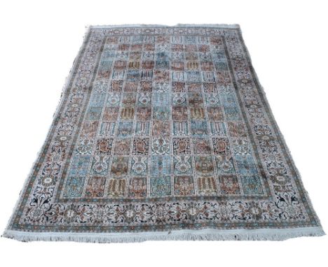 A Persian silk Qom rug, the field of differing tile designs within a wide stylised border, 2.72 x 1.83 m   Condition Report  