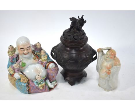A famille rose figure of Budai, 20cm high, unglazed base with four-character mark; together with: a small figure of Budai, 15