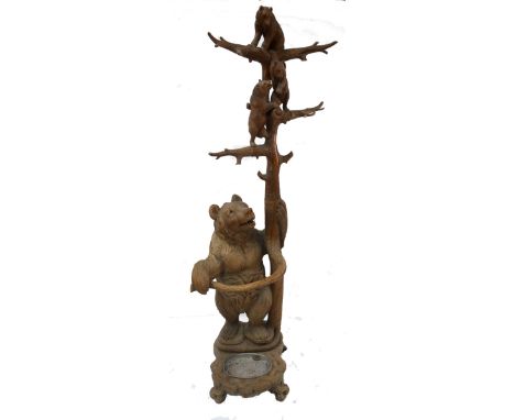 A late 19th century Swiss Black Forest carved bear hall stand, formed as a large bear with three bear cubs climbing a tree, i