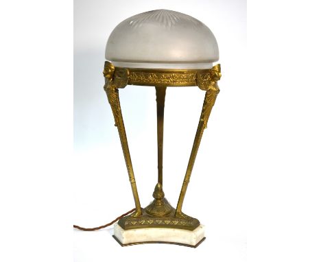 An ormolu Egyptian revival style triform table lamp with opaque glass shade, raised on a white marble base, c.1910, 45 cm hig