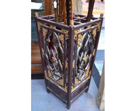 A Chinese, lacquered wood stick, or other, stand with looped metal handle, and with a reticulated and floral design, 79 cm hi