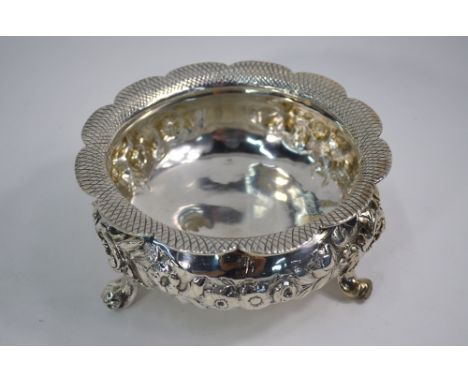 A heavy quality William IV silver basin with scale-pattern lobed rim, floral-embossed rose garlands and foliate scroll feet, 