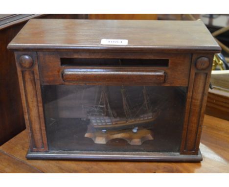 An antique mahogany table top posting box, with glazed panel door 30 x 13 x 21 cm high to/w a miniature model of a man-o-war 