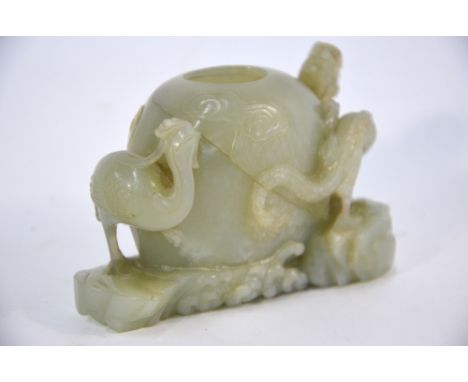 A green jade brushpot or other object for the Scholar's Desk, carved  with a Dragon and a Phoenix supporting the cylindrical 