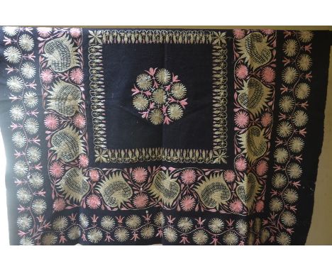 An early 1900s black velvet panel embroidered in silks with floral roundel to centre and birds and fruit, 150 x 150 cm, a sim