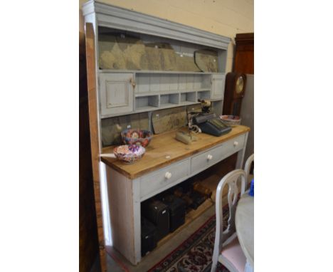 A large painted pine kitchen dresser with scrubbed top, plate with shelves and cupboards, three frieze drawers and pot-shelf,