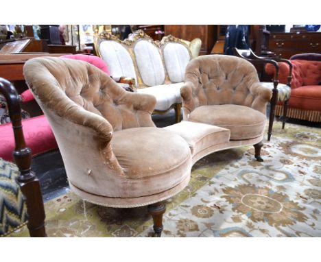 A Victorian button backed conversation seat, formed as a pair of revolving chair-back seats flanking a shaped centre panel, r