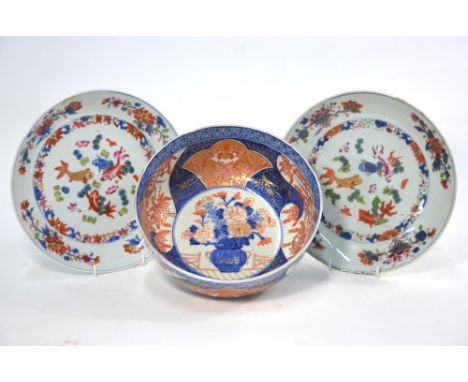 A pair of Chinese rose-imari dishes; each one decorated with fan-tailed goldfish and floral designs, 22cm diameter; together 