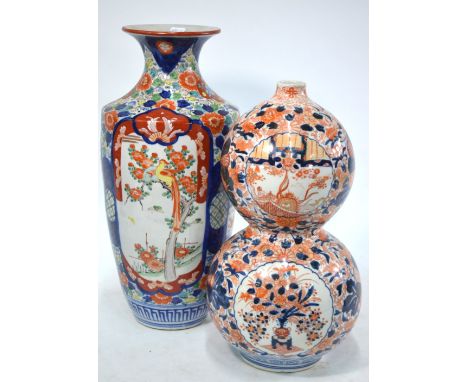 An Imari double gourd vase, decorated in typical underglaze blue, orange and gilt with panels of flower arrangements and Tsur