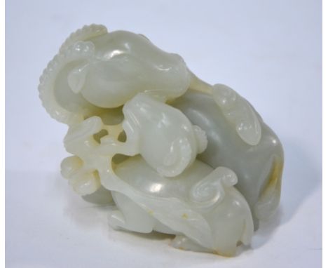 A green jade of pale or whitish hue, carved as a ram or goat, seated beside a kid and holding lingzhi fungus together, 9cm lo