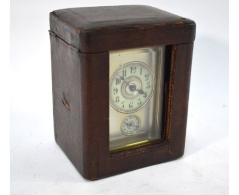 A brass carriage clock with alarm striking on bell, the silvered dial with ivorine chapter ring and subsidiary alarm dial, 15