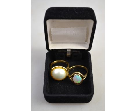 A yellow metal ring stamped 750 set mabe pearl, size N to/w a 9ct yellow gold ring set with oval opal, size P 1/2 (2)