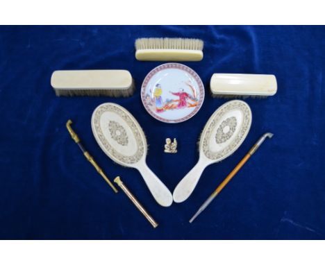 A pair of Chinese floral carved ivory hairbrushes (circa 1920), a polychrome saucer, Chien Lung mark but not period, 12 cm; a