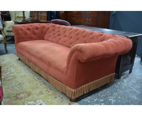 A button upholstered Chesterfield sofa raised on turned mahogany legs to ceramic castors, circa 1900, 218 cm long