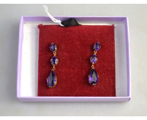 A pair of amethyst drop earrings, of good colour, yellow metal, in gallery style claw setting, for pierced ears