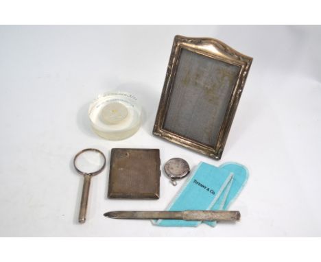 A Tiffany & Co sterling letter knife in original cloth slip, to/w an engine-turned cigarette case, Birmingham 1927, a folding