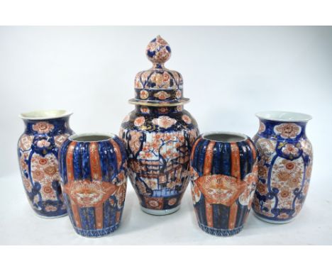 An associated Japanese Imari 'garniture' of five vases, comprising: one vase with domed cover and knop finial; two vases with